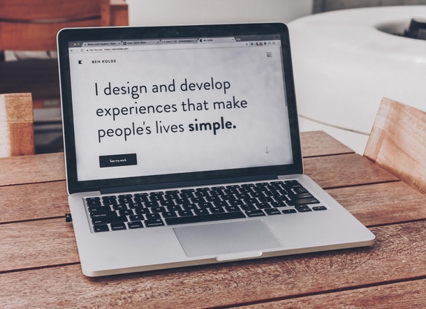 A laptop computer open on a desk with a Front End Developer services website open